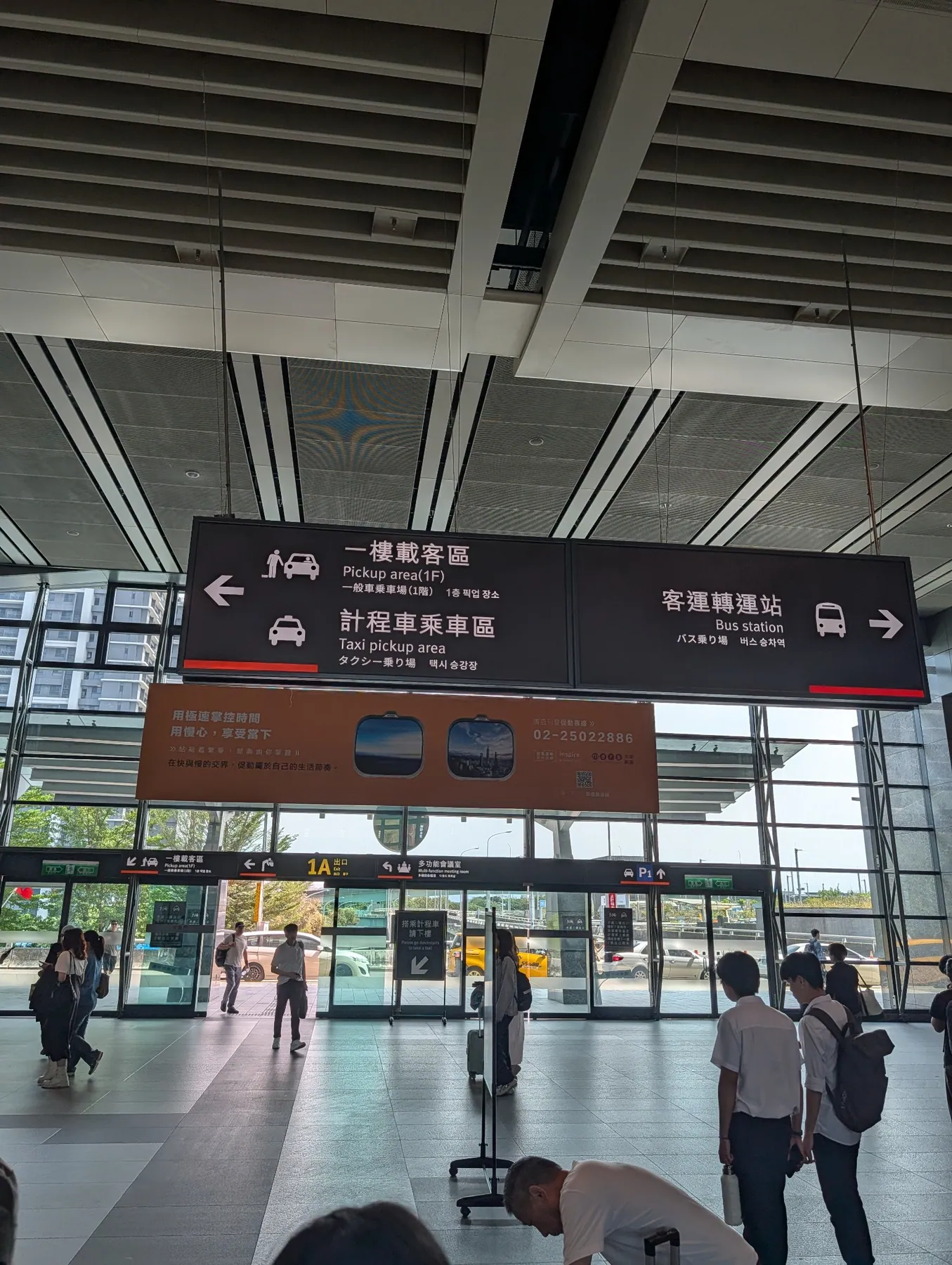 Pickup and taxi sign points left; bus station sign points right